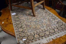 A small Persian design rug, with Europeanised Heriz type design and tassled ends 124cm x 74cm