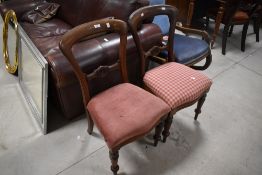 A pair of Victorian mahogany balloon back dining chairs, with moulded rails and serpentine fronted