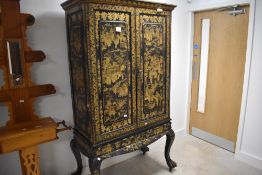 Fine 19th century Chinese export black and gilt lacquer two-door cabinet, having a moulded cornice