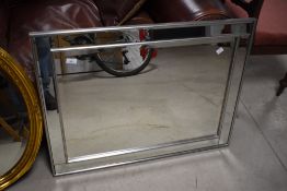 A modern rectangular bevelled wall mirror with grey/silver coloured painted frame 63cm x 83cm