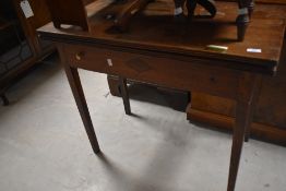 A 19th century oak fold over tea table, of rectangular form with reeded edge detail and tapering