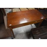 An Edwardian mahogany fold-over tea table, of hinged rectangular form with in laid rail and tapering