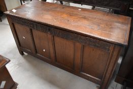An 18th century oak four panel coffer, of oblong for with hinged top lifting to reveal the