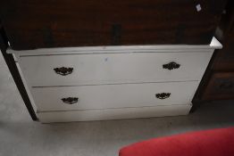 A late 19th/early 20th century white painted pine chest of two drawers, each with shaped gilt