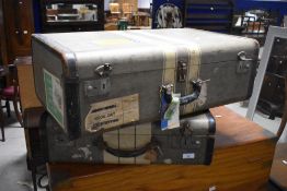 Two vintage canvas covered and leather trimmed suitcases, each with material linings, largest 66cm