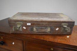 A vintage chestnut brown stitched leather suite case with quilted red material interior, 65cm wide