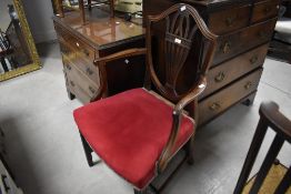 A George III mahogany shield-back carver dining chair, with pierced vase form central splat,
