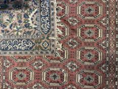 Two vintage area rugs, an Arabesque floral bordered motif in lilac, blue and green, measures 53 x 75