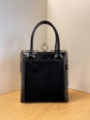 A vintage black PU and suedette hand bag with diamante studded crescent moon closure and yellow