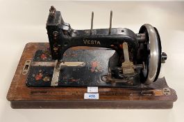 A vintage German Vesta hand-cranked boat shuttle sewing machine with original instruction manual, in