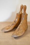 A pair of wooden shoe lasts, measuring 9 inches / 23 cm long in the base of the foot.