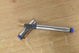 A boxed Waterman Forum cartridge/ converter fill fountain pen in brushed steel with blue bands