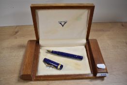 A Visconti Voyager piston fill fountain pen in Lapis Blue with decorative cap band having Visconti