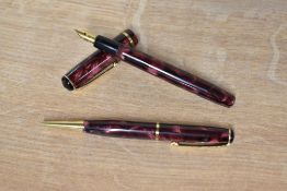 A boxed Burnham lever fill fountain pen and pencil set in Rose marble with single cap band the pen