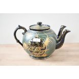 An unusual Victorian Aesthetic Movement Jackfield-style double spouted teapot, featuring a black and