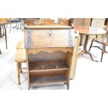 A late 19th or early 20th Century Arts & Crafts style bureau with bookshelf under, width approx.