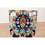 A late 19th-century to early 20th-century Arts and Crafts pottery tile in the style of William De