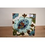 A late 19th-century to early 20th-century Arts and Crafts pottery tile in the style of William De