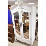A traditional painted Mahogany armoire wardrobe having wooden