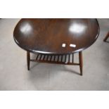 A dark stained Ercol coffee table of oval form with spindle undertier, approx. 99 x 83cm