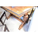 An early 20th Century oak drawer leaf dining table
