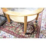 A vintage oak and glass circular coffee table, labelled G Plan, diameter approx. 83cm, on castors