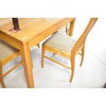 A modern golden oak dining table and four similar railback dining chairs, approx. 107 x 86cm