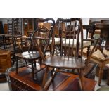A dark stained Ercol carver chair and similar rocking chair in slightly lighter shade