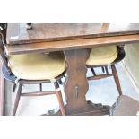 A dark stained Ercol drawer leaf dining table and set of four similar Ercol chairs