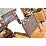 A 19th Century carved oak miniature half tester bed, either for doll or a specimen piece the head