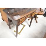 A 19th Century oak lowboy in the Georgian style with brass drawer handles and shaped apron, on