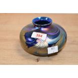 A 1993 Paul C. Brown studio art glass decorative vase, featuring an iridescent oil-slick lustre