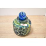An unsigned Mdina glass bottle vase of short necked cylindrical form with associated stopper, pontil