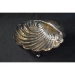 An Edwardian silver shell motif bowl, raised on three ball feet, marks for Sheffield 1904, maker