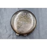 A silver makeup mirror compact, of circular form having a repousse map of India with rubies