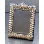An Elizabeth II silver mounted photograph frame, having gadrooned and scroll decoration with a