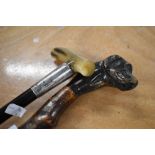 Two walking sticks an ebonised walking came measuring 87cm long with a bone handle and a