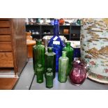 A small quantity of late 19th-century green glass poison type bottles; sold with a blue glass John
