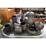 A vintage Wedgwood 'Black Basalt' coffee service, featuring a coffee pot, coffee cans, lidded