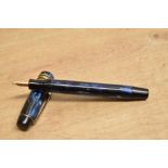 A Golden Guinea button fill fountain pen in Blue marble with one Broad and two narrow cap bands