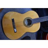 A Kasuga classical guitar with padded gig bag