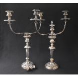 A pair of silver plated three branch candelabras, having fluted knopped stems with a central