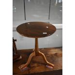 A reproduction stained frame pedestal table having circular top and triple splay legs, diameter
