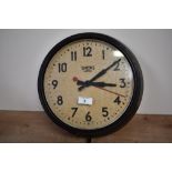 An early to mid 20th-century Smiths Sectric bakelite wall clock, featuring a yellowed dial face with