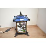 A vintage Kind Light Manufacturing Tiffany-style table lantern, featuring colourful panels with