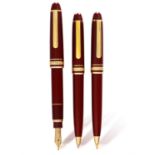 MONTBLANC: A 'MEISTERSTRUCK' BURGUNDY PEN AND PENCIL SET • A gold plated and lacquer fountain pen •