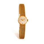 GARRARD: A LADY'S 9K GOLD WATCH, 1975 • Manual wind movement • circular silver dial • 12 o’clock