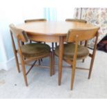 A G-Plan teak dining table, raised on turned, tapered legs  29"h  48"dia extending to 66"dia with an