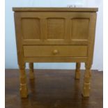 A Robert 'Mouseman' Thompson light oak sewing box with a hinged lid, over a single drawer, raised on