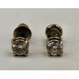 A pair of diamond stud earrings